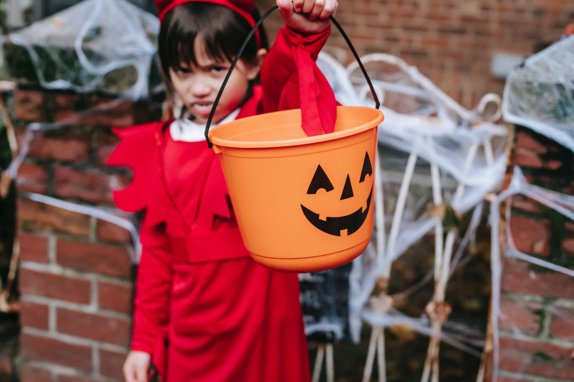 cute little girl with halloween bucket